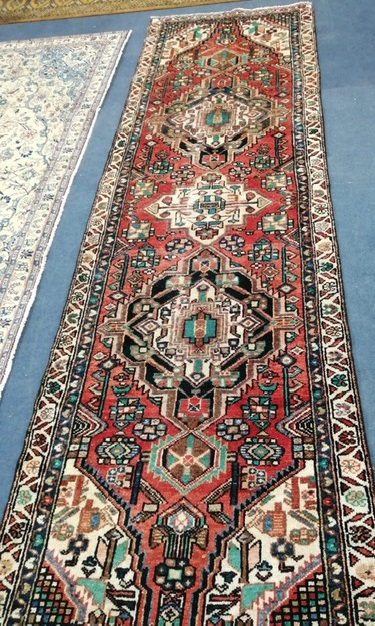 A Karajeh red ground carpet 284 x 94cm